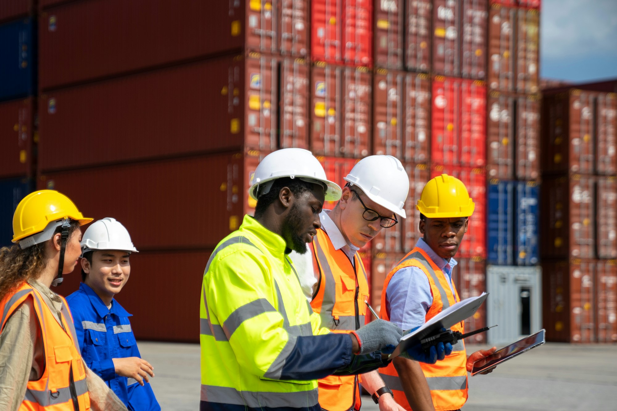 Group of engineer worker and manager in the shipping yard container.